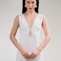 Long, gold necklace with a snake pendant from the Kembali collection