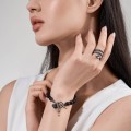 Wood carved snake motif bracelet with silver accents from the Kembali collection